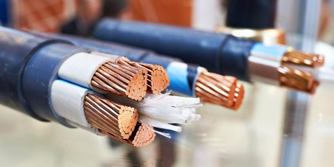 A table with an assortment of cables and wires for power connections.