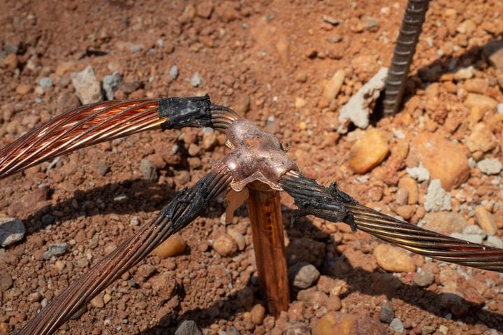A group of copper wires on the ground.