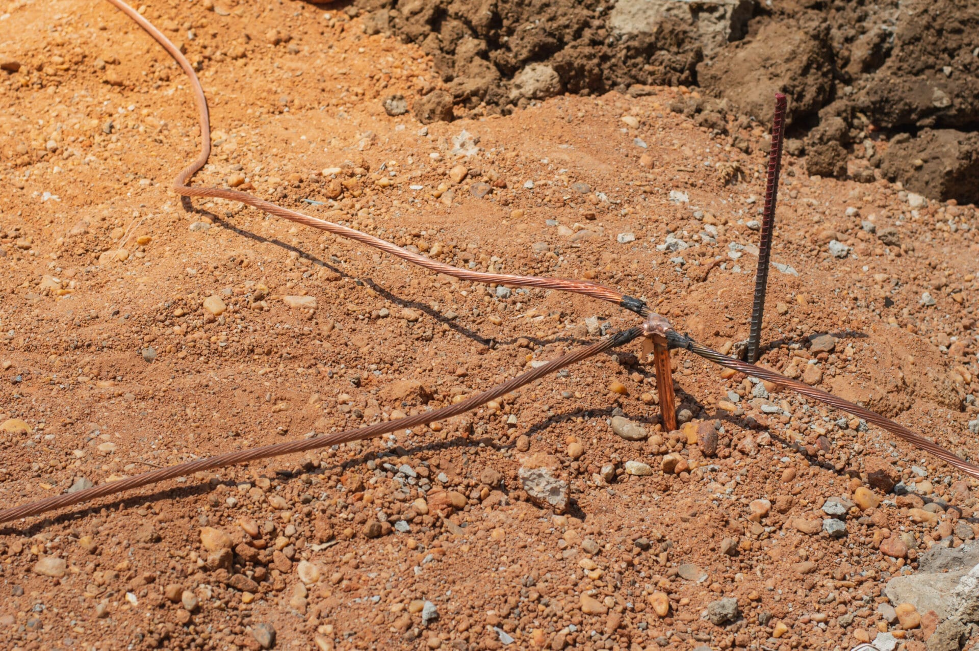 A man is digging a hole in the ground with a shovel. A man is digging a hole in the ground with a shovel.